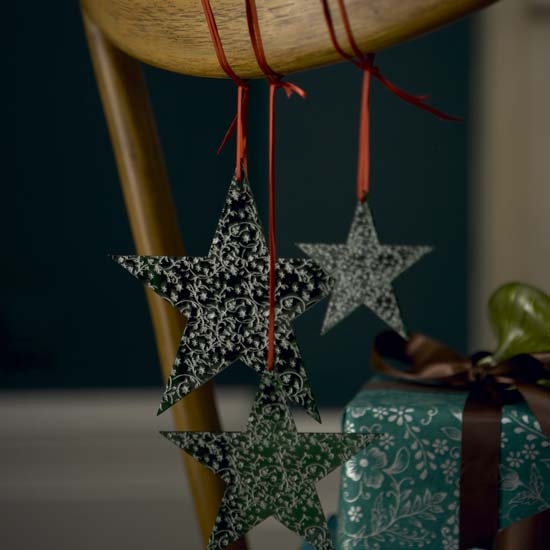 Tie tree ornaments, like stars, to the back of your chairs